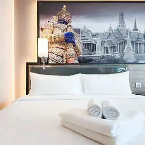 A room at Citrus Sukhumvit 11 Bangkok with a Thai-art headboard mural
