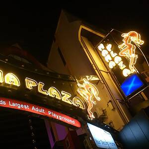 The Nana Plaza entrance on Sukhumvit Soi 4 lit up at night, the centre of the guest-friendly hotel cluster