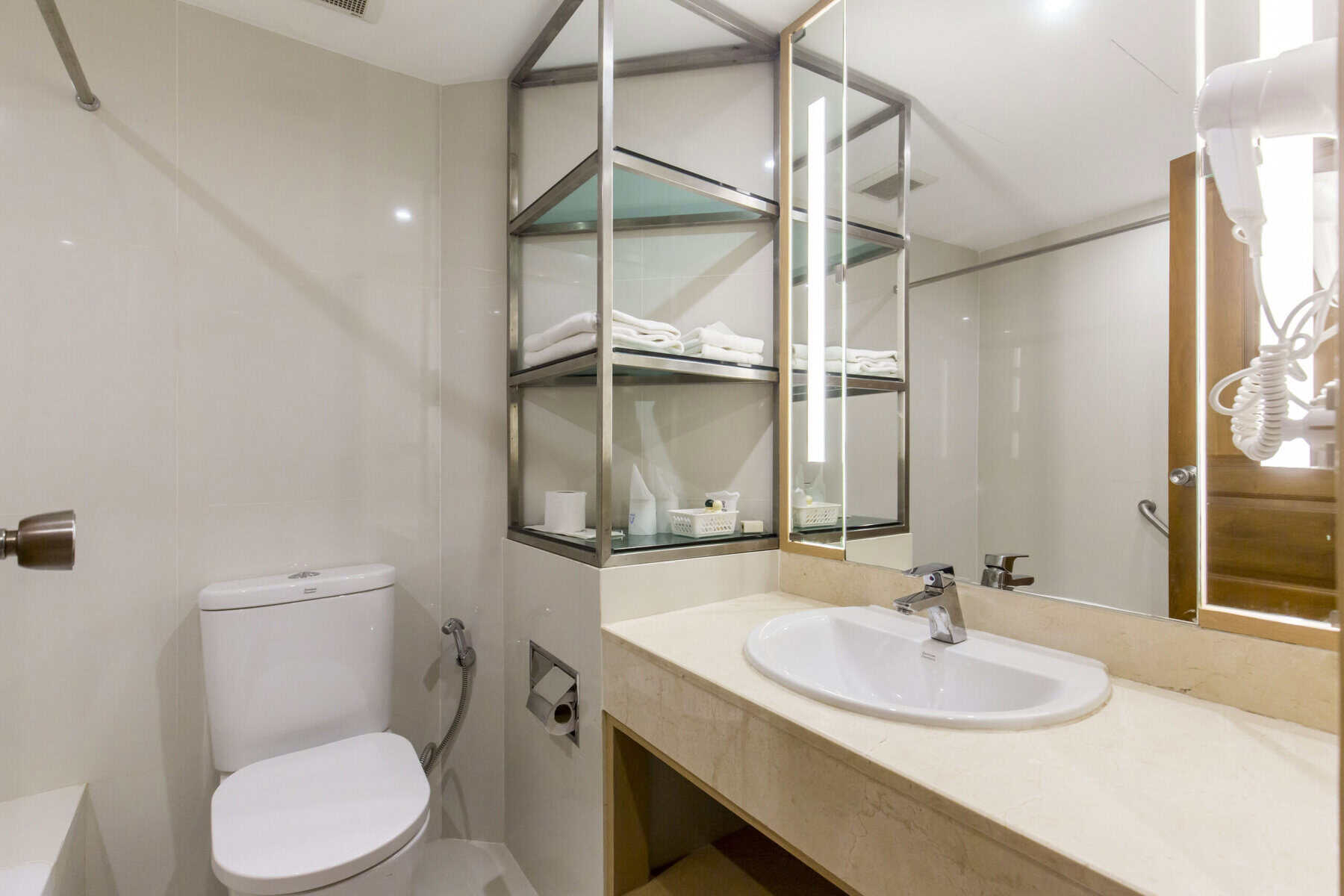Renovated bathroom at the Nana Hotel Bangkok, with marble counter and walk-in shower