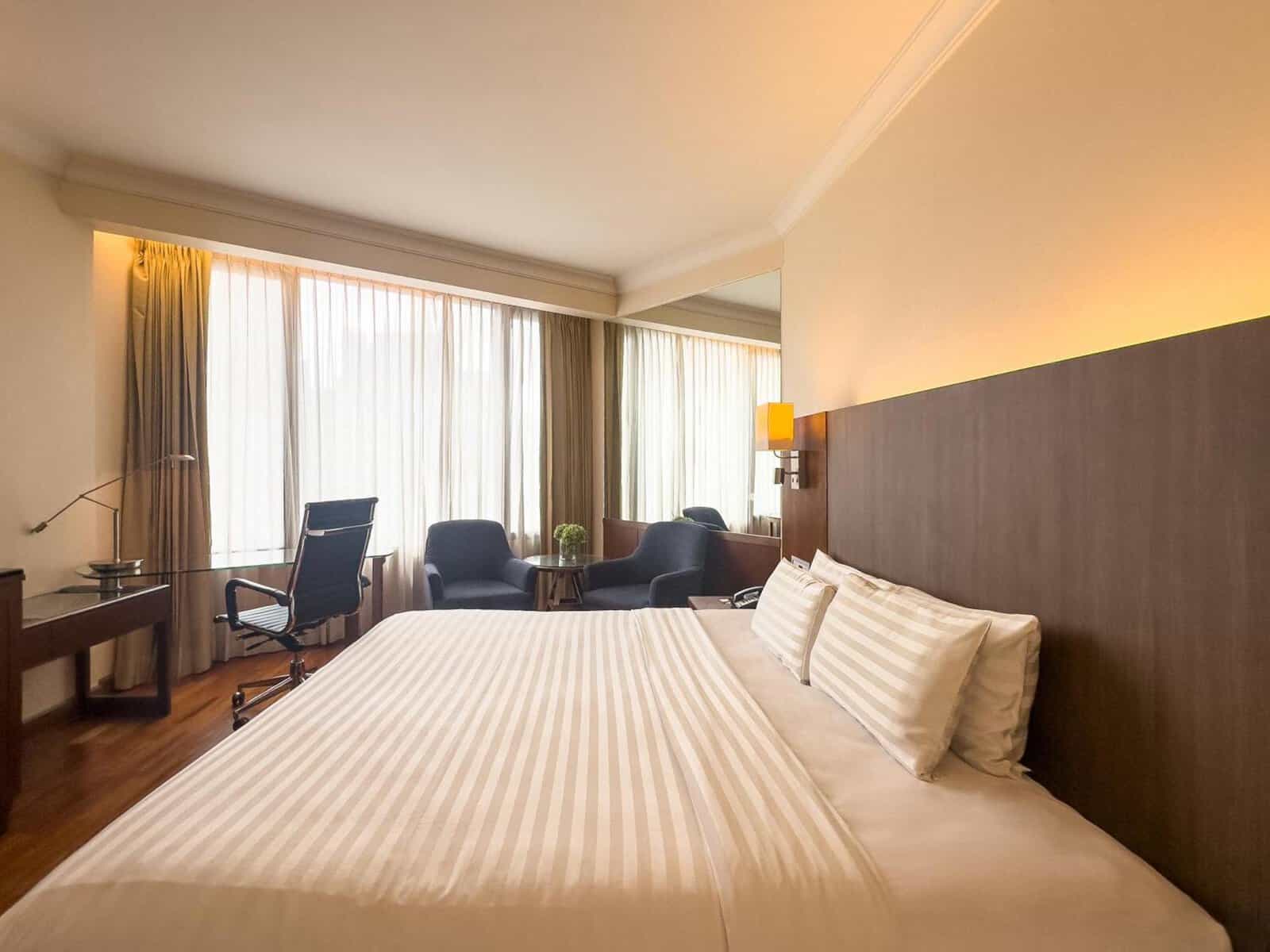 Rembrandt Hotel Bangkok room with armchairs and a work desk by the window