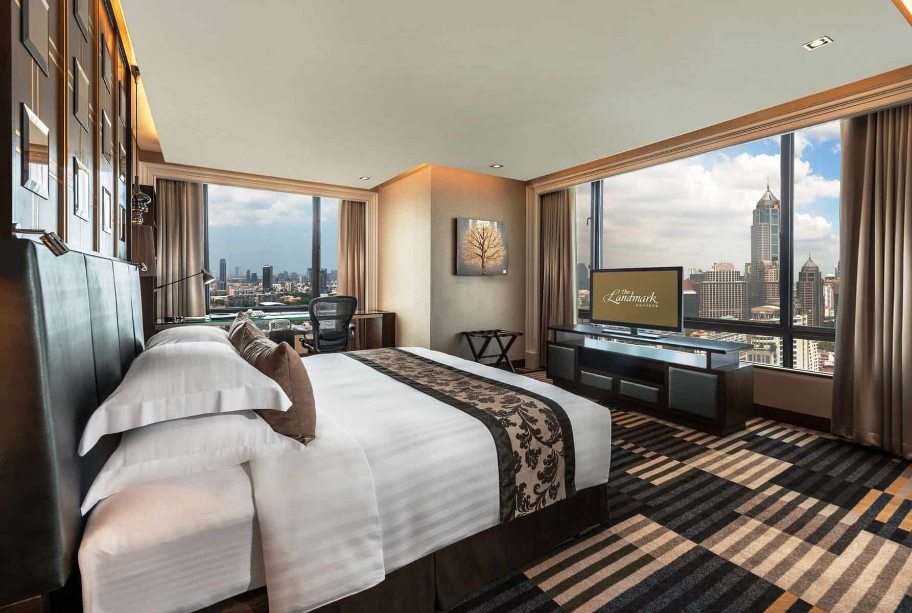 A corner room at The Landmark Bangkok with floor-to-ceiling windows on two sides over Sukhumvit