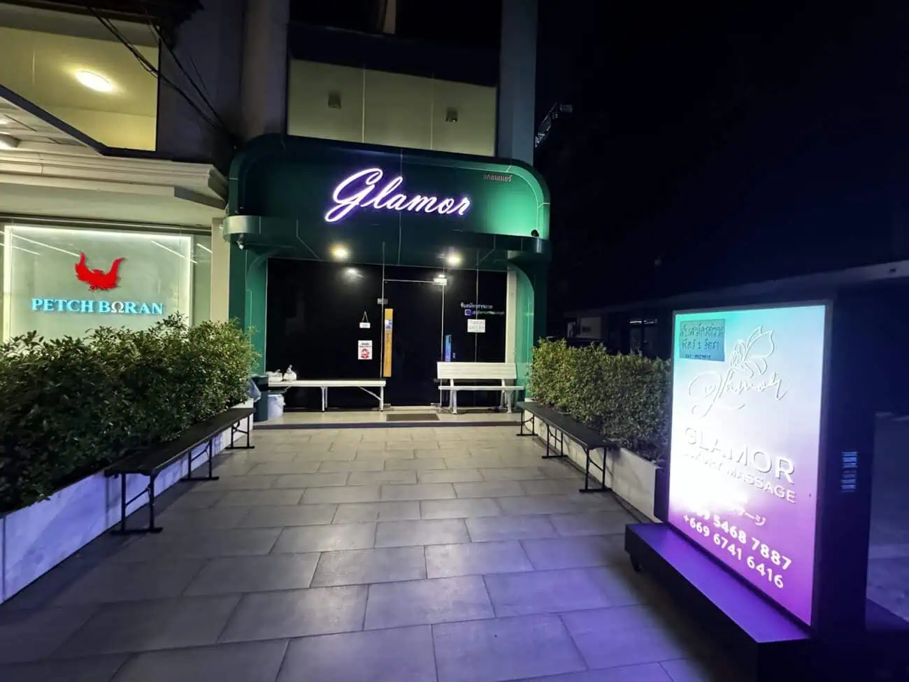 Illuminated Glamor sign and lightbox at the entrance to Glamor Nuru Massage, Sukhumvit Soi 31, Bangkok, at night