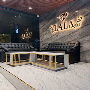 Lobby at LALA Nuru Massage on Sukhumvit Soi 26, with the illuminated LALA sign on marble