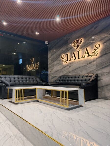 Lobby at LALA Nuru Massage on Sukhumvit Soi 26, with the illuminated LALA sign on marble