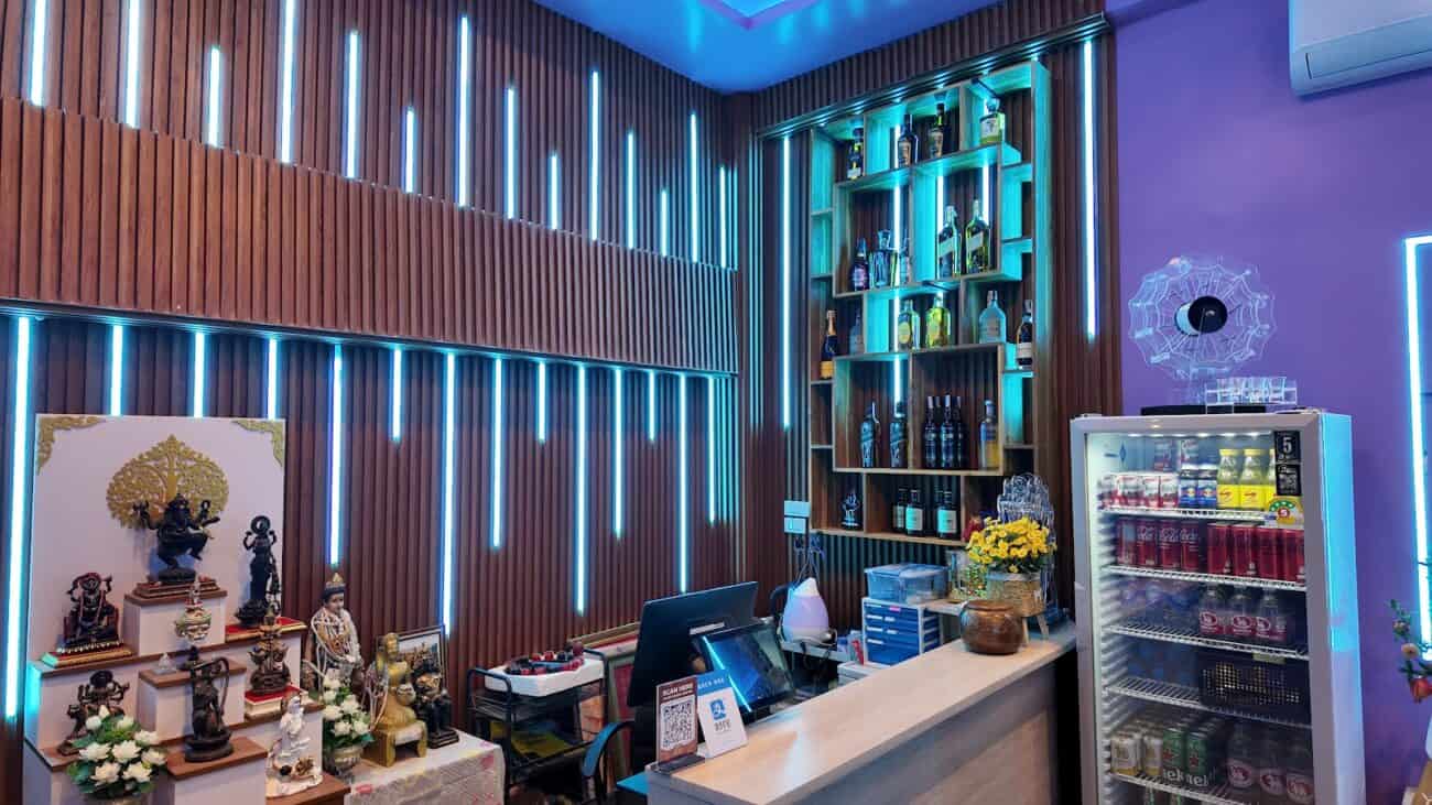 KTV bar at Lumi Nuru Massage & KTV, Sukhumvit 39, Bangkok, with LED-lit wood slats and a spirits shelf