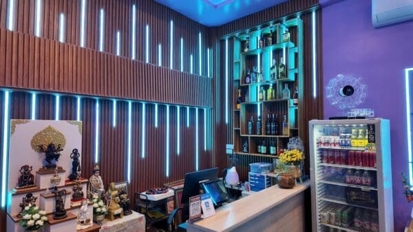 KTV bar at Lumi Nuru Massage & KTV, Sukhumvit 39, Bangkok, with LED-lit wood slats and a spirits shelf