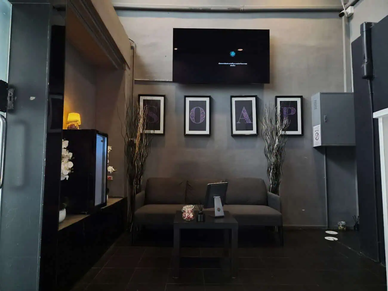 Reception lounge at Mitu Soap, Sukhumvit Soi 23, Bangkok, with framed SOAP lettering above the sofas