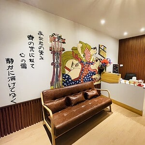Reception at Sukebe Nuru Massage, Sukhumvit Soi 18, with shunga wall mural and Japanese calligraphy