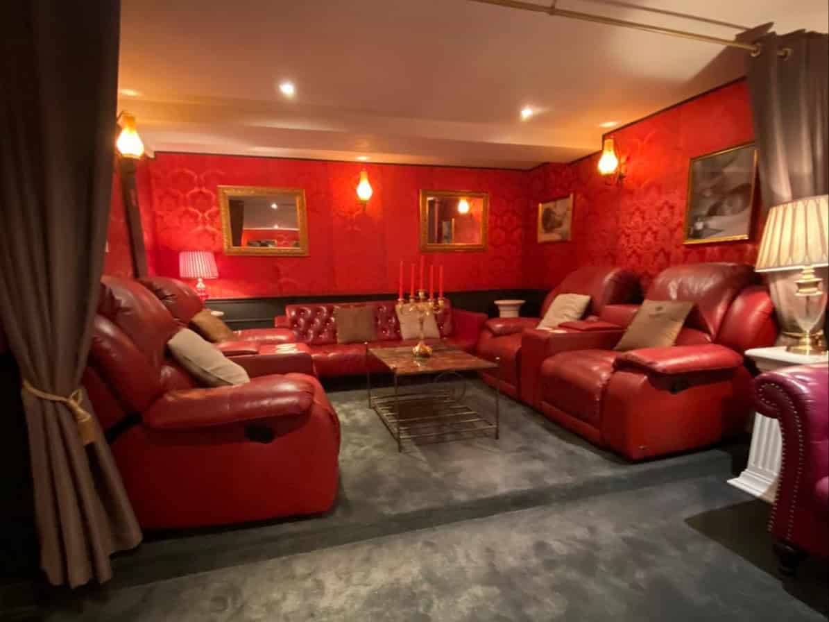Red lounge with leather sofas at 102 Massage, Sukhumvit Soi 24