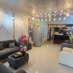 Marble-walled reception lounge with grey sofas at Airy Massage, lower Sukhumvit, Bangkok