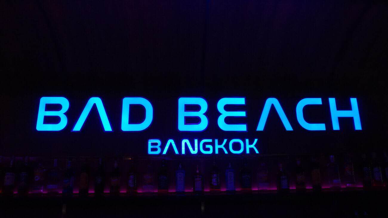 Illuminated Bad Beach Bangkok sign above the back bar at Bad Beach, Soi Cowboy