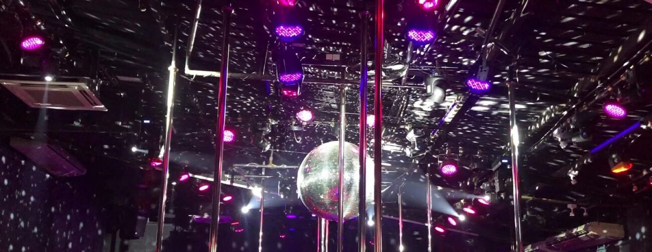 Stage poles, disco ball and lighting rig inside Billboard on the top floor of Nana Plaza, Bangkok