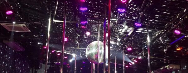 Stage poles, disco ball and lighting rig inside Billboard on the top floor of Nana Plaza, Bangkok
