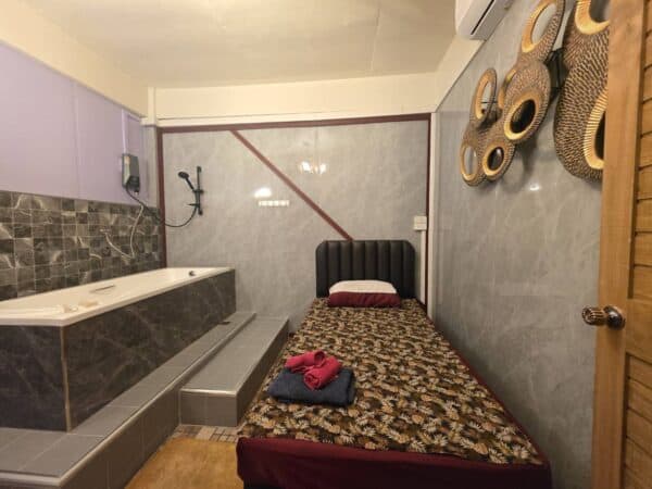 Massage room with a bath and shower at ELLE Nuru Massage, Ratchadaphisek Road near Asok