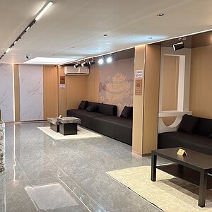 Reception lounge with a marble counter and black sofas at Eve Massage Spa, Sukhumvit Soi 31, Bangkok