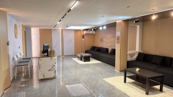 Reception lounge with a marble counter and black sofas at Eve Massage Spa, Sukhumvit Soi 31, Bangkok