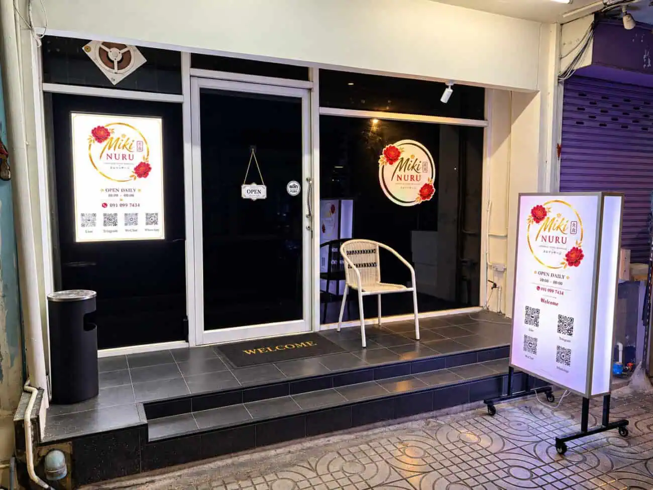Storefront of Miki Nuru Massage on Sukhumvit Soi 22, with its lightbox signs and opening hours