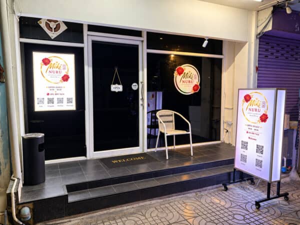Storefront of Miki Nuru Massage on Sukhumvit Soi 22, with its lightbox signs and opening hours