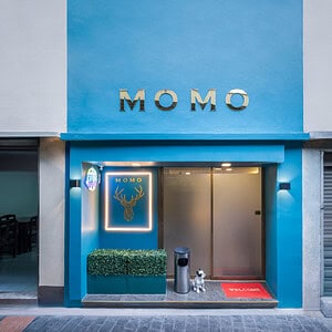 Blue storefront of Momo Massage on Soi 53/1 by BTS Thong Lo, with gold MOMO lettering