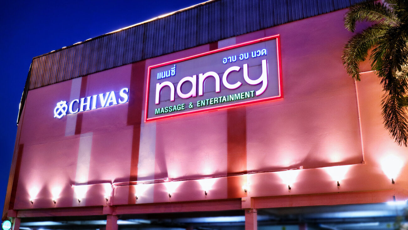 Illuminated Nancy Massage & Entertainment sign on the building on New Phetchaburi Road, Huai Khwang, Bangkok