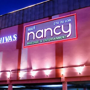 Illuminated Nancy Massage & Entertainment sign on the building on New Phetchaburi Road, Huai Khwang, Bangkok