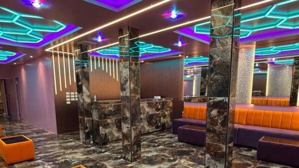 Ground-floor lobby at OHO777, Sukhumvit Soi 33, with marble pillars, orange seats and LED ceiling
