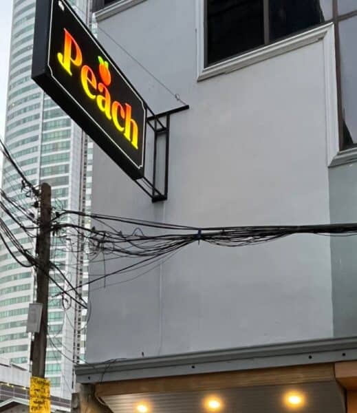 Illuminated Peach sign above the massage shop on Sukhumvit Soi 20, Bangkok