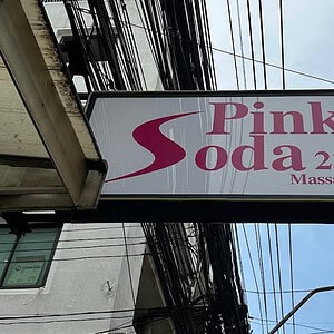 Pink Soda 23 Massage lightbox hanging over Sukhumvit Soi 23, Bangkok