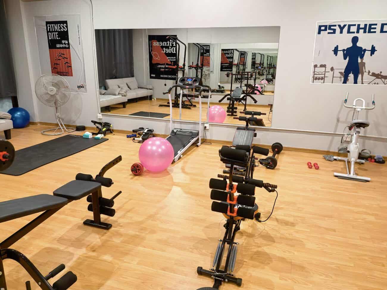 Gym-themed role-play room at Psyche Dream Spa, RCA, Bangkok, with the Psyche Dream wall sign