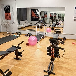 Gym-themed role-play room at Psyche Dream Spa, RCA, Bangkok, with the Psyche Dream wall sign