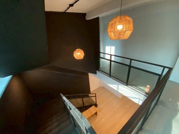 Stairwell with rattan pendant lamps inside SENTO on Ekkamai Road, Bangkok
