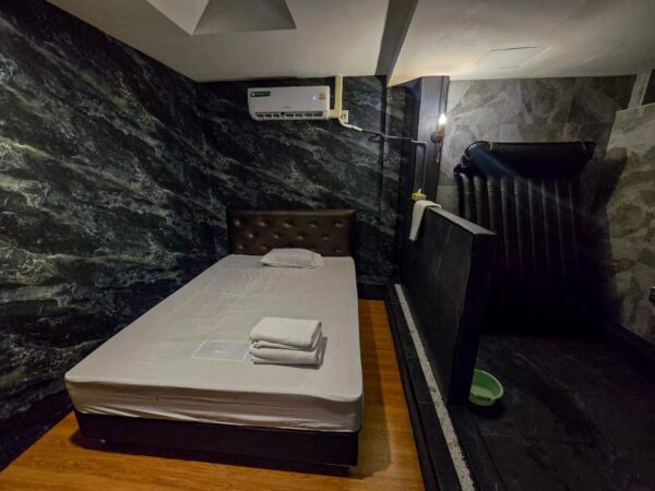 Room with a bed and a shower area at Stella Nuru Massage, Sukhumvit Soi 10, Bangkok
