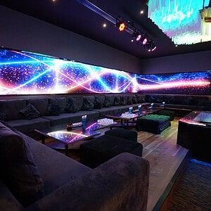 Lounge with long sofas and an LED light wall at The PIMP club, Wang Thonglang, Bangkok