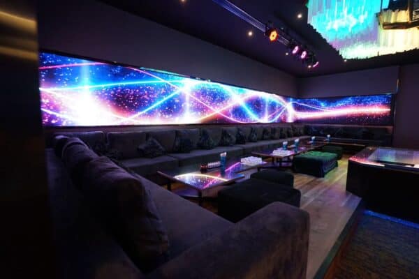 Lounge with long sofas and an LED light wall at The PIMP club, Wang Thonglang, Bangkok