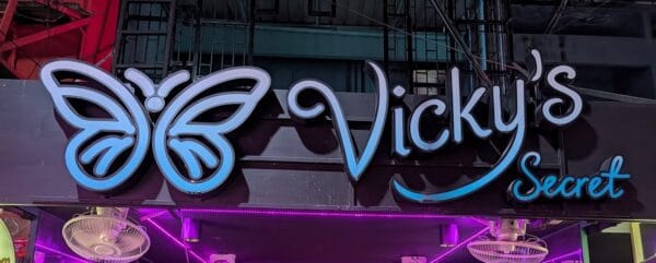 Vicky's Secret butterfly neon sign over the bar on Soi Cowboy